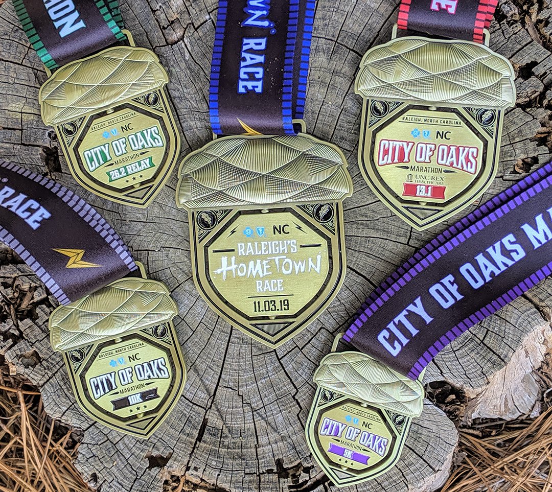 OaksMarathon's tweet image. The City of Oaks has never looked better! Introducing the 2019 Finisher Medals for The City of Oaks Marathon, @RexHealthcare Half Marathon, Marathon Relay, the Old Reliable 10k and the Acorn 5k. Register at cityofoaksmarathon.com to earn your finisher medal on November 3!