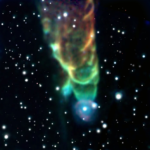 A funnel-shaped gas cloud ranges in color from red at the open end to orange, yellow, green, and then blue at the tip