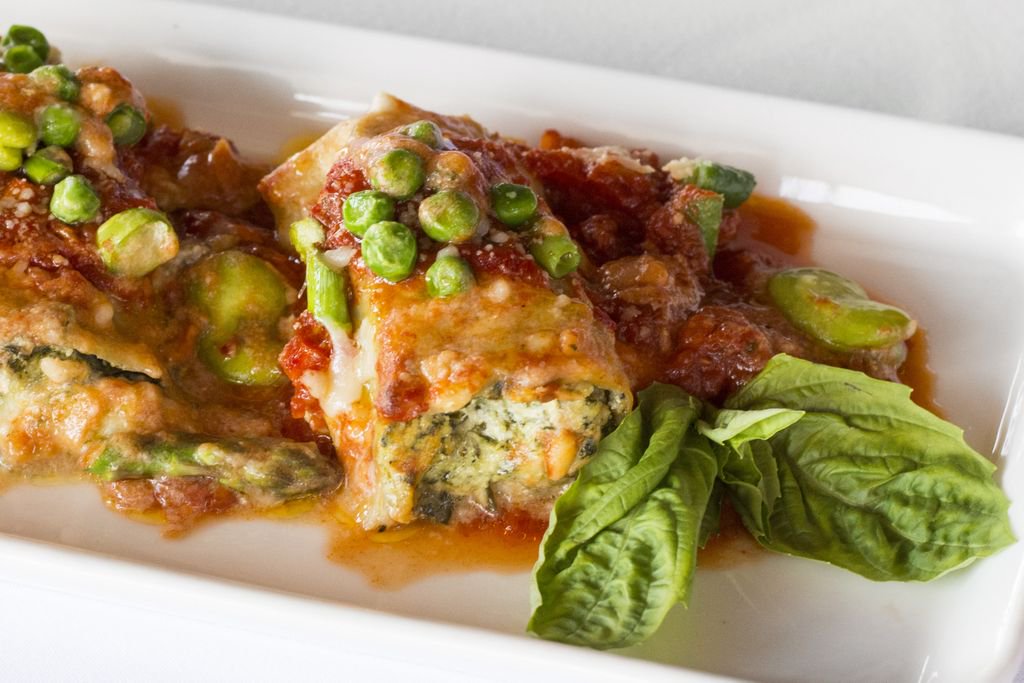 Primavera sauce, rich, creamy ricotta and savory herb and spinach filling inside our house-made baked pasta... Our Manicotti is the perfect bite for brunch, lunch, or dinner!