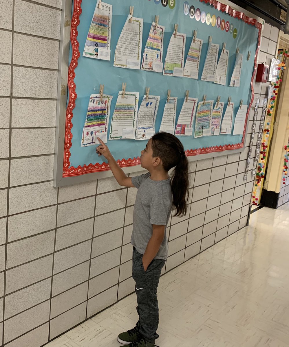 In a quiet moment returning to class, a 2nd-grade dual language scholar eagerly reviews his feedback on a get-to-know-you letter to Ms. Cortéz #ganasdeaprender