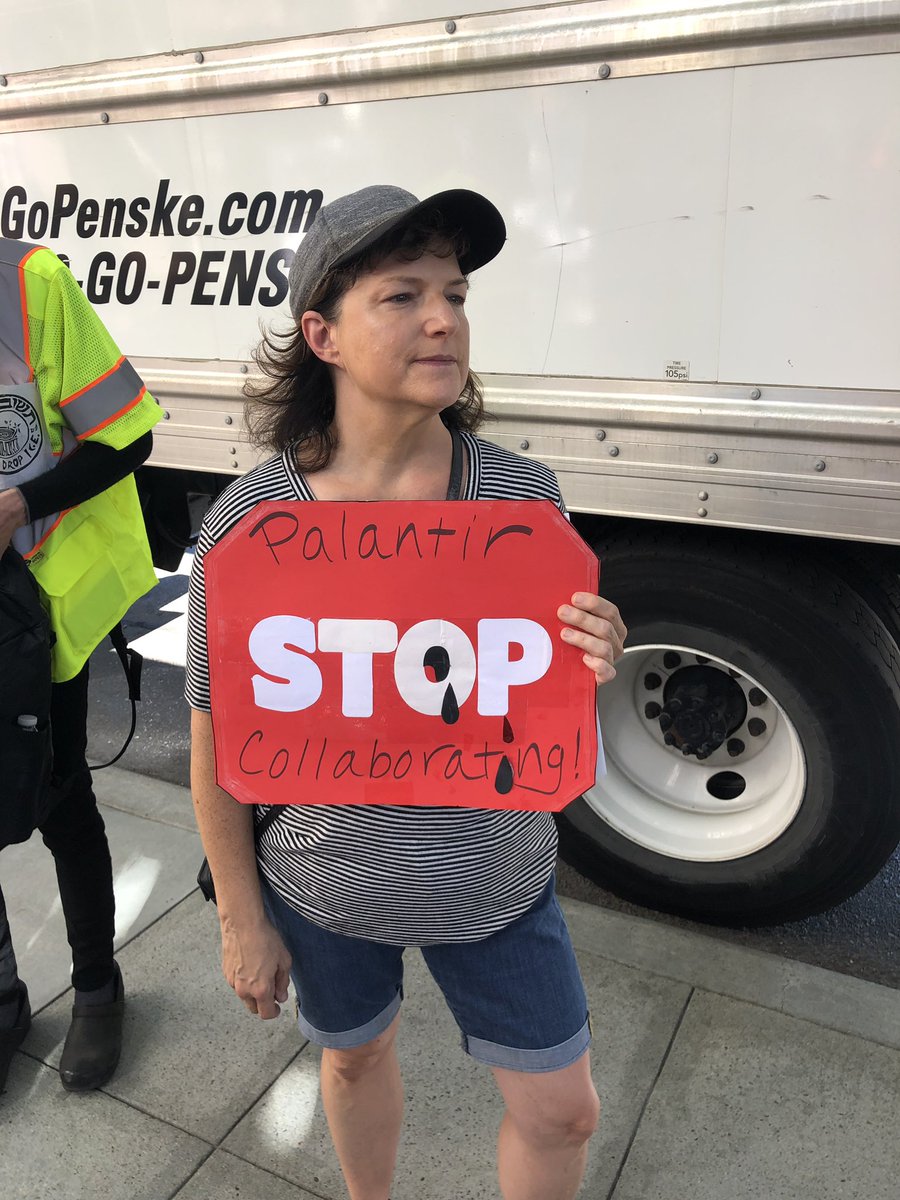 Palantir Stop collaborating In the background is one of the four trucks blocking the view of the protest from the street