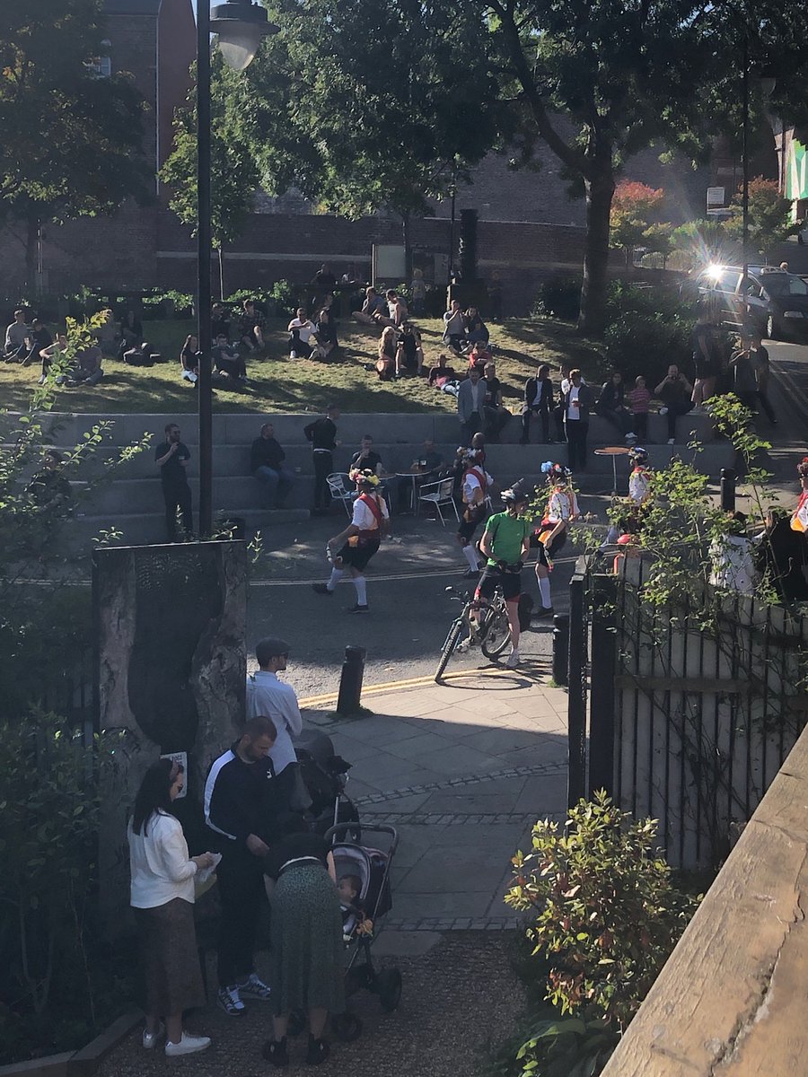 Morris dancers passing the Cluny as the sun shines on the Ouseburn valley