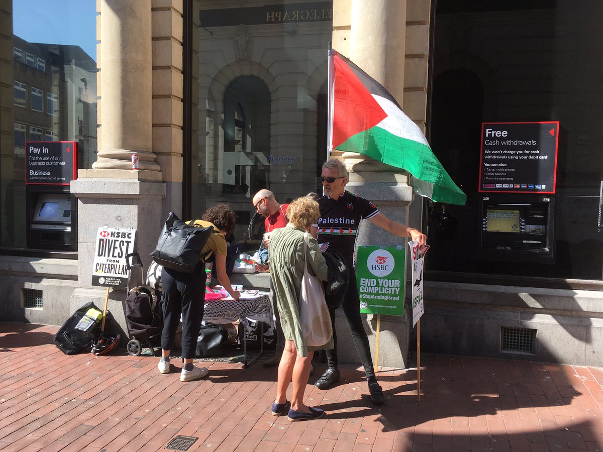 BrightonPSC's tweet photo. Brighton action protesting #HSBComplicity in Israel’s war crimes. Our die-in closed the main Brighton branch briefly and 100s of people stopped to take leaflets and learn more. Time for @hsbc to divest from @CaterpillarInc #StopArmingIsrael https://t.co/IXYXRaAYj6