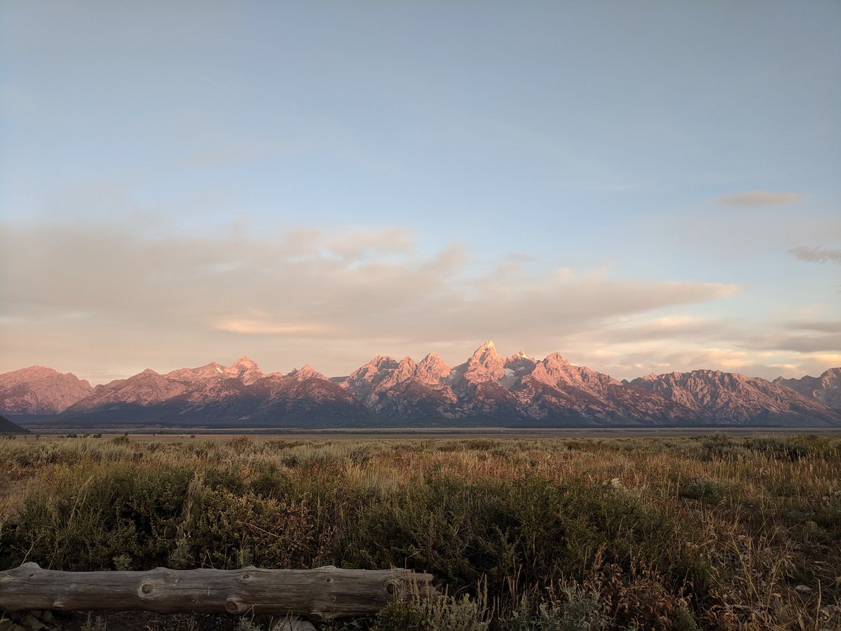 Morning y'all. I'm having phone charging issues &amp; spotty service. I think I'm going to post an all day question for #RoadTripChat. Headed to Verizon when they open. In the meantime, check out the beautiful #sunrise when that first light caught the Tetons this am💙 #FindYourPark