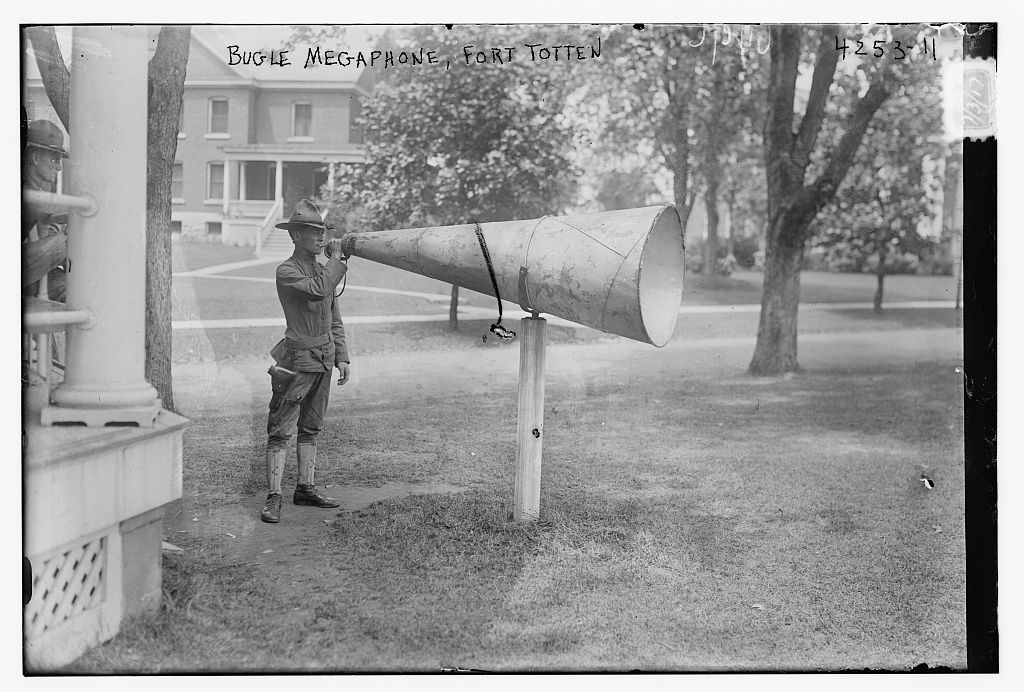 Black and white image of bugler at megaphone at Fort Totten.