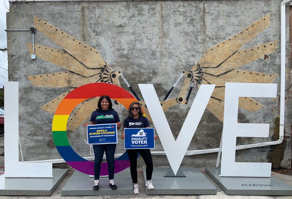 HRC staff and candidate Sheila Bynum-Coleman in front of LOVE sign