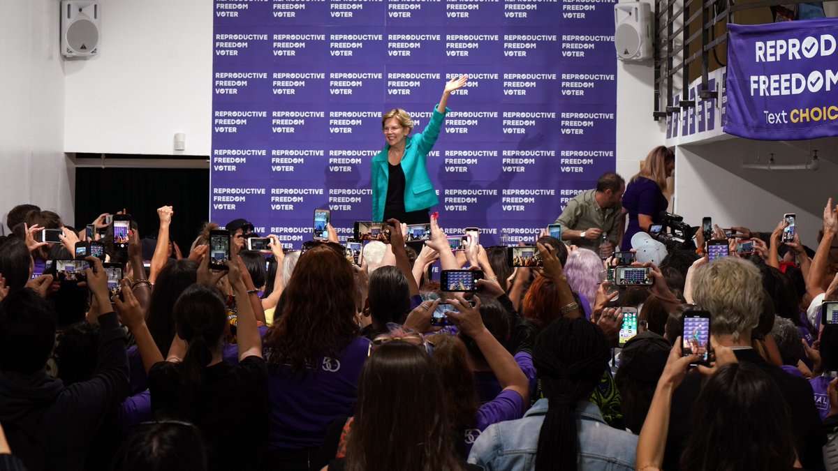 Elizabeth Warren waves at a crowd of supporters at the NARAL forum.