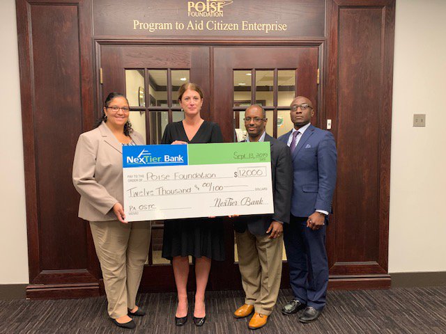 NexTier's tweet photo. The #travelingcheck is back and headed down 79 to the Poise Foundation. https://t.co/I2sKx6bY9n. Pictured: Karris Jackson,POISE Foundation, Lara Wozniak, NexTier. Mark S. Lewis, President and CEO of POISE Foundation, and Tchetchet G. Digbohou, POISE. #nextiergivesback https://t.co/LdWhmia9df
