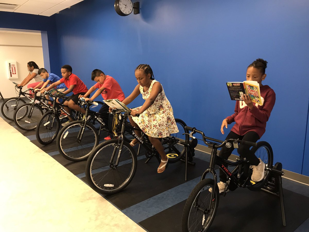 KellyeWJZ's tweet photo. While these 4th graders @FerdinandTDayES let their legs do the work on stationary bikes, the books they’re holding take their minds to far away places. “You’re riding but you’re also reading &amp; it’s training your muscles &amp; your brain," said Ava Walker. Watch tonight @ 5. @ACPSk12 https://t.co/4ShSv4N3nA