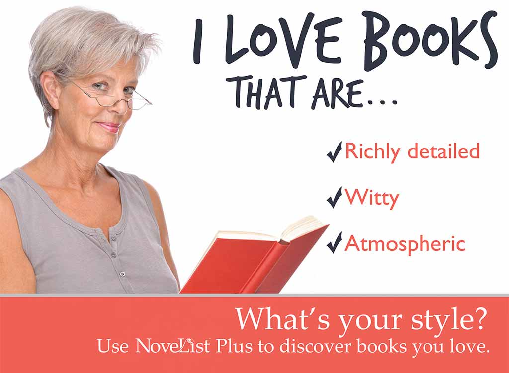 a photo of an older woman with glasses holiding a book and smiling at the camera