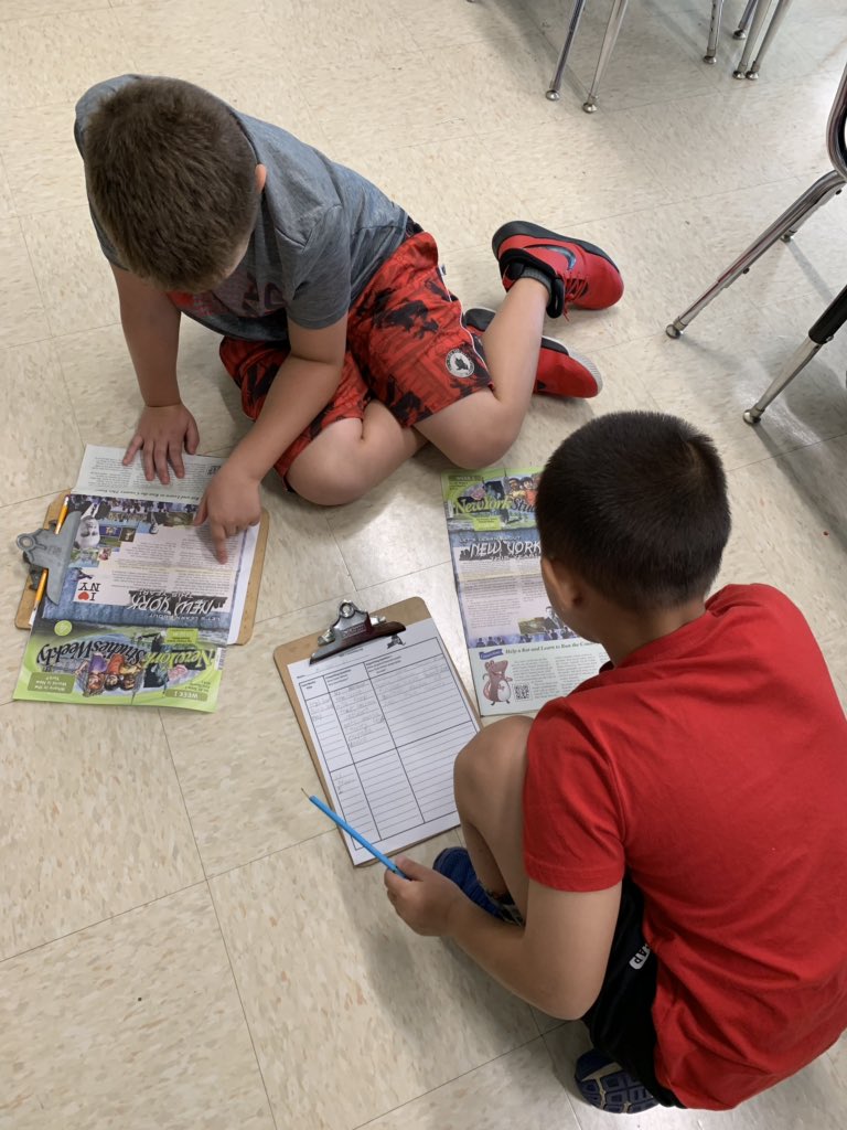 Fourth graders reading social studies weekly newspapers and logging their learning about our essential question “How does where you live matter?” #InquiryBasedLearning #NYSGeography #ReadToLearn @AlisonJClark @MrsWintersSR