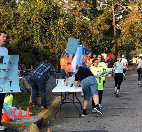 MotownMarathon's tweet photo. #TBT to race day and all of our amazing water station volunteers cheering on the runners at the 2019 Morgantown Marathon! We’re so thankful for your support. Many of our water stations are dedicated to a veteran and are filled with encouraging signs from the community! #RunMotown https://t.co/Wm2aa24LWF