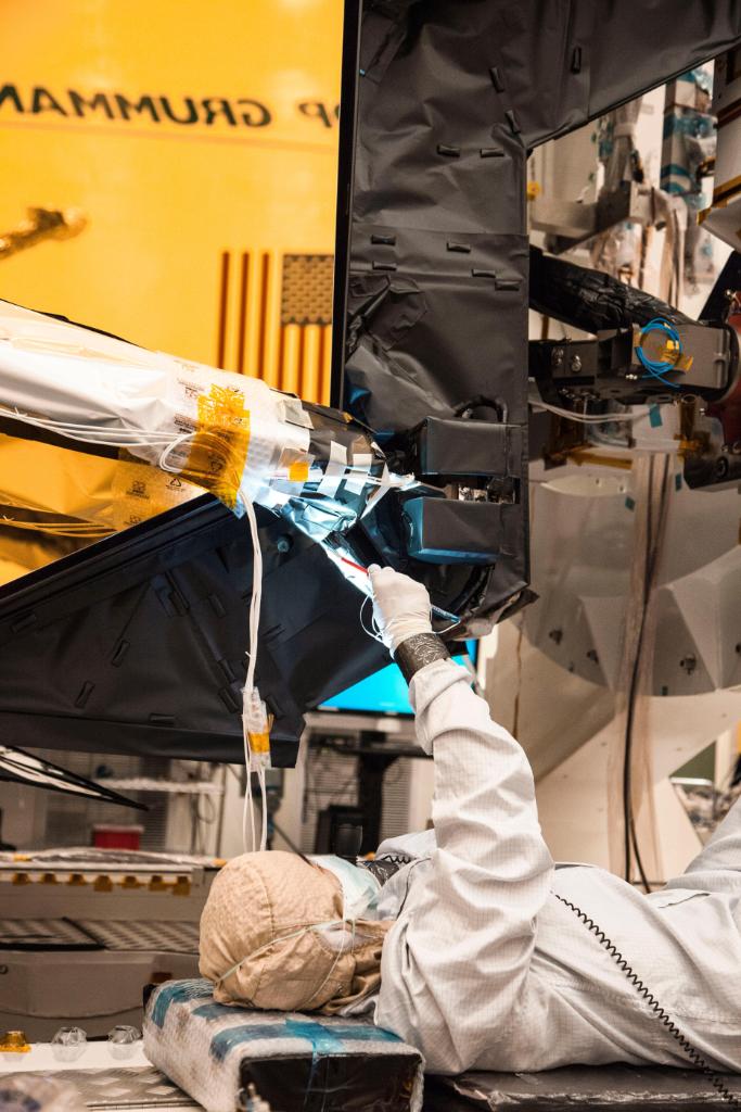 Techs work on the secondary mirror of the James Webb Space Telescope. 