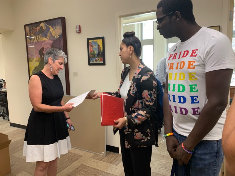 People giving the official letter to DC staffer