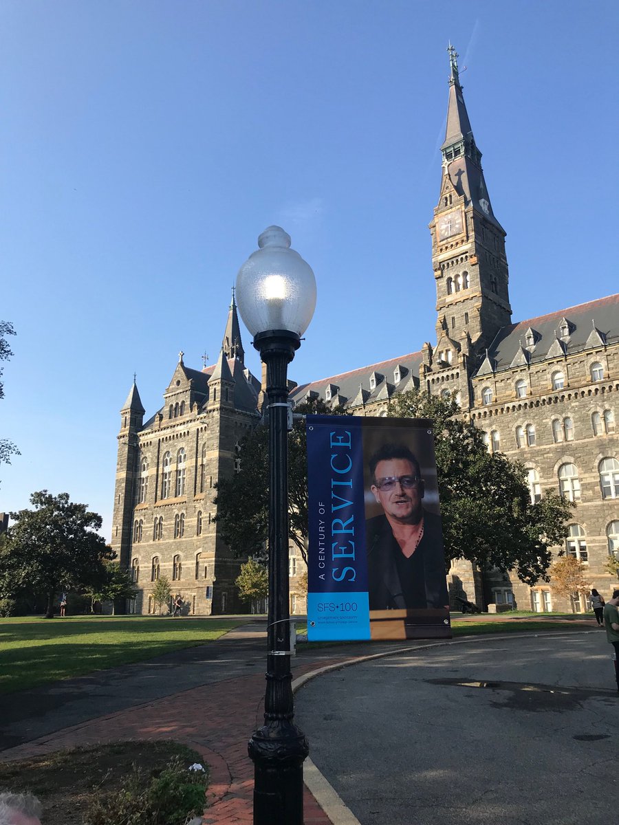 HemalKVaidya's tweet photo. Professor #Bono,  Your picture is up at @Georgetown! After #Mumbai, how about bringing the lads back here for another finale⁩?  Plenty of Irish pubs - first (few) rounds on me! ⁦@U2⁩ ⁦@u2songs⁩ ⁦@u2gigs⁩ #ahisma #JT2019 #service ⁦@georgetownsfs⁩ #preach https://t.co/SZHF5vUYuW
