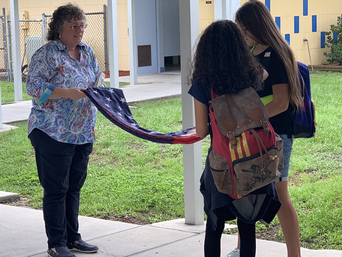 HCPSClairMel's tweet photo. Our safety patrol sponsor, Ms. Terle, teaches our newly inducted safety patrols how to properly fold the American flag. @AchievementSch @HillsboroughSch https://t.co/tNx3r5DKZA