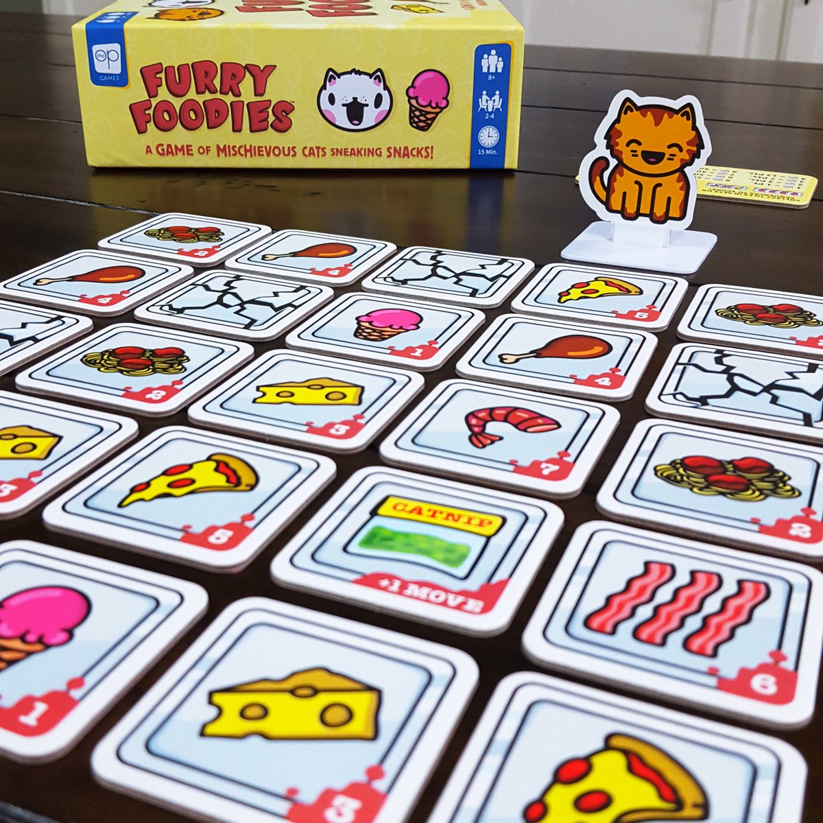 WCGamesMN's tweet photo. Furry Foodies: https://t.co/aYKn1vAwPN Fun 2-4 player 5x5 grid collection tile game. Cat pushes a column/row x2 and takes food (or broken plate) that falls to the floor. Collect same number or sequential tiles to score at end. Top score wins! @USAopoly #whitecabinetgames https://t.co/BhV8farCH8