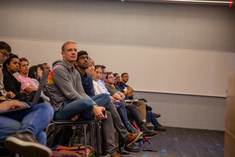 A seated audience watches Mengdi Wang present at RL Day 2019.