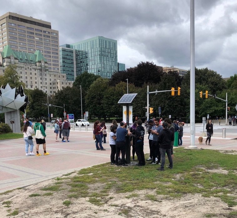 SunChargeCanada's tweet photo. You are downtown and notice a low battery signal on your cell phone? No need to panic, just head over to @ottawacity Hall and #PlugInOnUs These folks did just that. We count 7 of them getting recharged. We’ve got room for 10. @JimWatsonOttawa @TimTierney #PowerUpOnTheGo ☀️☀️☀️ https://t.co/Bw8ZLui5Uw