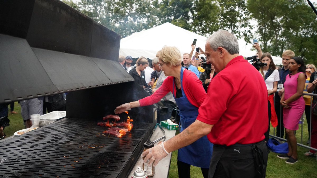 Elizabeth Warren grills steak at the Polk County Steak Fry in Iowa.