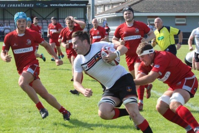 CarmAthletic's tweet photo. Skipper @dan_evans7 is surrounded by the Pembroke defence at Athletic Park. The #RedAndBlacks scored 5 tries in the 31-10 win. Photo courtesy of @SueBows https://t.co/x6mSbWDBaG