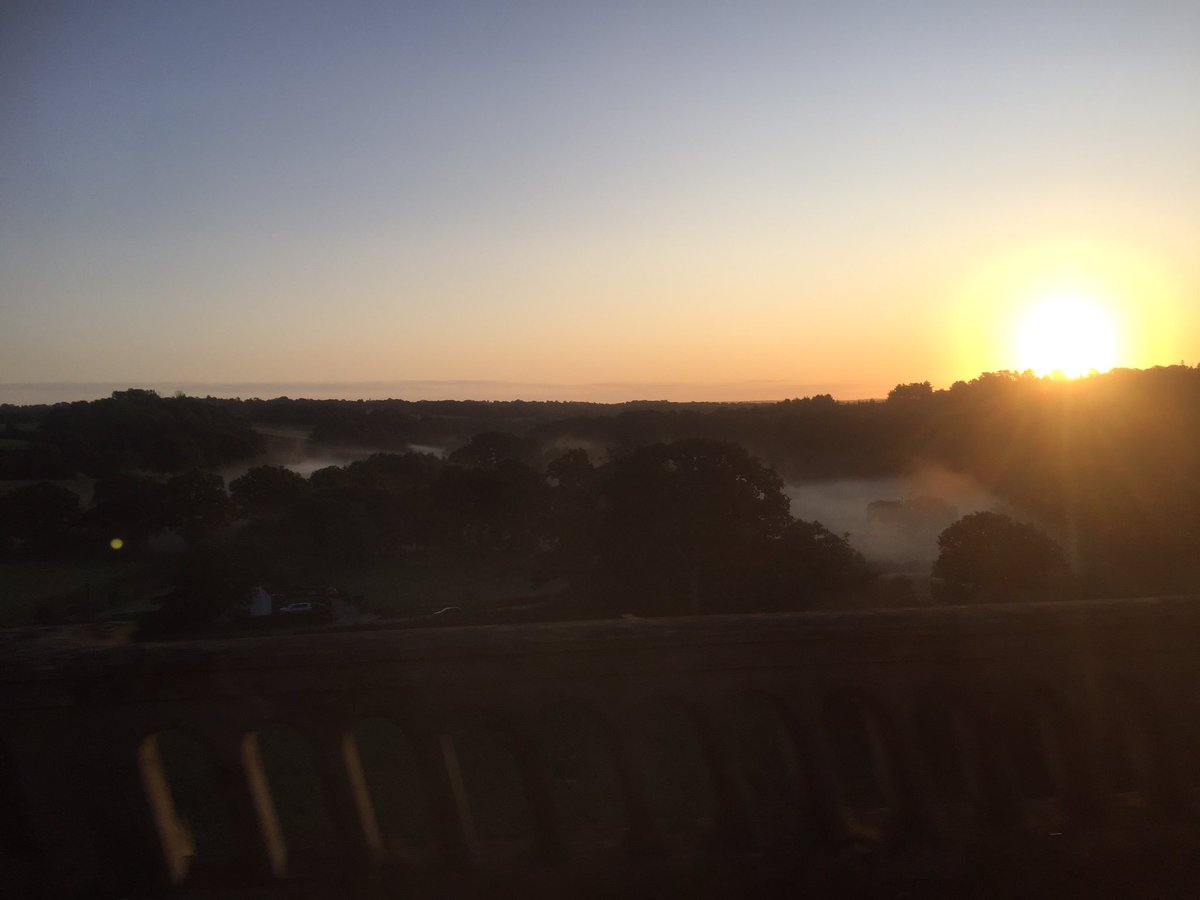 RobKRead's tweet photo. Earlier than normal train on the autumnal equinox. Sun’s first rays just catching us on Balcombe viaduct #commuteview https://t.co/NpIbAhj5Gl