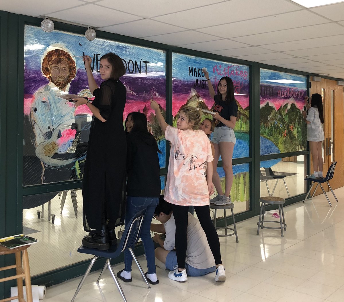 AP Studio Art Students are working hard painting the cafeteria windows!