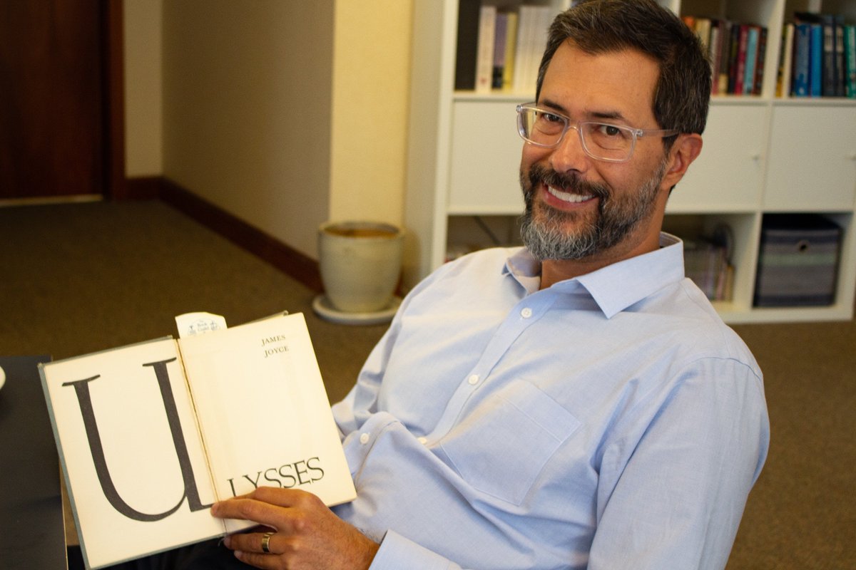 ACLU of Maine Legal Director, Zach Heiden, holding a copy of Ulysses by James Joyce