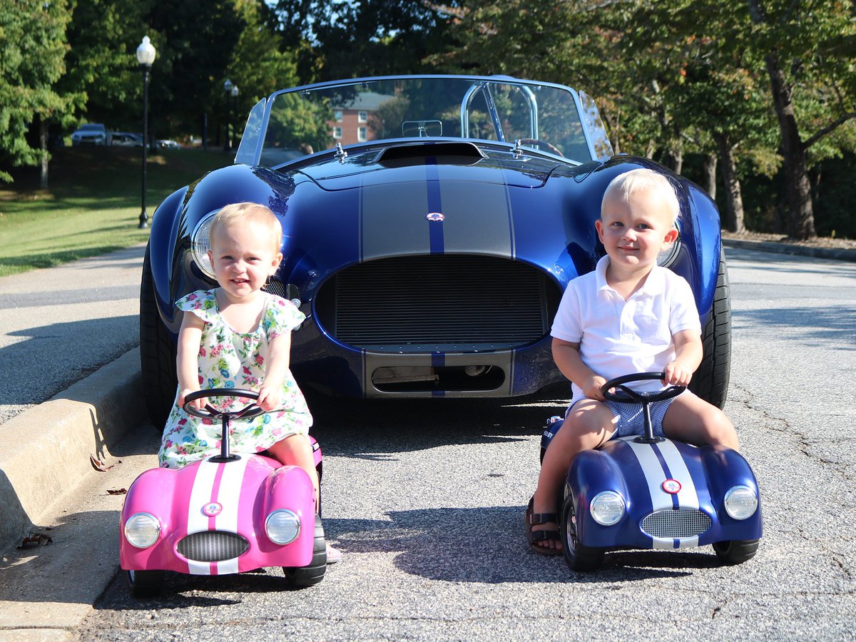 FactoryFive's tweet photo. Customer Lyn H. from Greenville, SC sent us this photo of his grandchildren, Coral and William, with their Roadsters parked next to his #FactoryFive #Mk4 #Roadster! Lyn received his Mk4 in 2018, and built it w/ a 351 stroked to 427, IRS, @Wilwoodbrakes, and 17" #Halibrand wheels. https://t.co/70XxkvE062