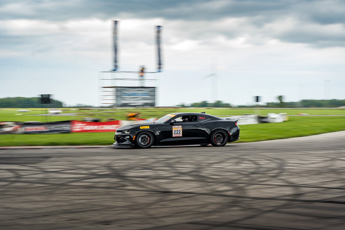 Buddschev's tweet photo. A couple stealth looking #Chevy’s ripping up the track last weekend at @TMPCayuga. Awesome to see these cars being pushed on the track like they were built to! #BuddsChev #Camaro #Corvette https://t.co/BCks9joi7G