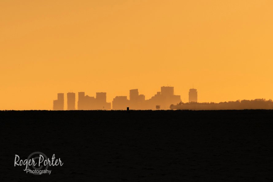 Boston at sunset from Cape Ann