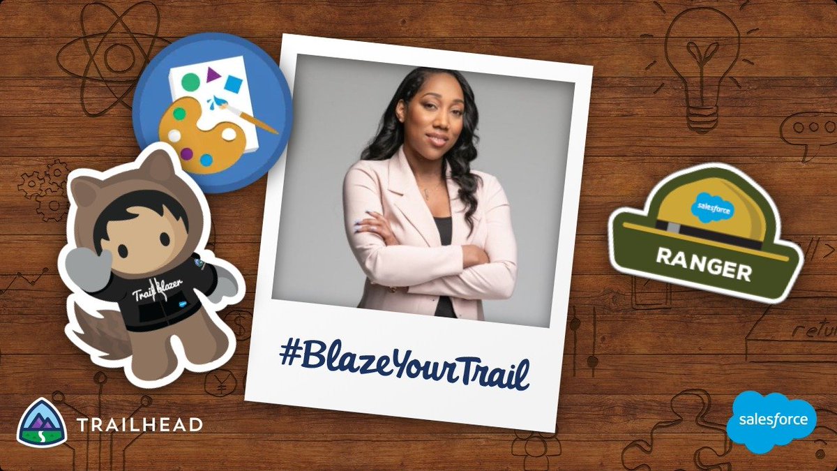 Image of Trailblazer inside a polaroid-style photo frame. The hashtag #BlazeYourTrail is written on the polaroid. Wooden table with Astro sticker, Trailhead badge, and Ranger hat. Trailhead logo and Salesforce logo.