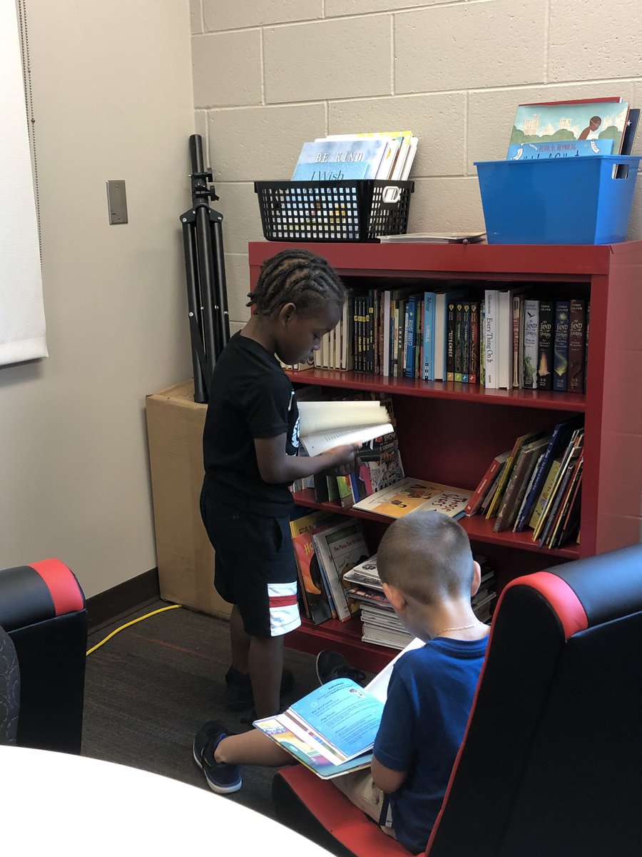 newsHgts's tweet photo. Jyare and Alexander picking out some books to read in the principals library. #choiceinreading https://t.co/O0FH38hfTO