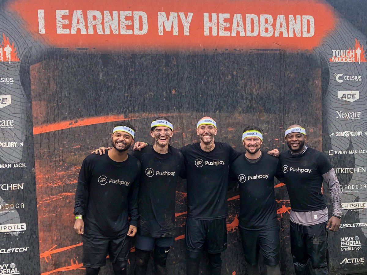 Pushpay's tweet photo. Sometimes team bonding involves headbands and tons of mud. 🏃 #toughmudder #teampushpay https://t.co/btsMSmW9ex