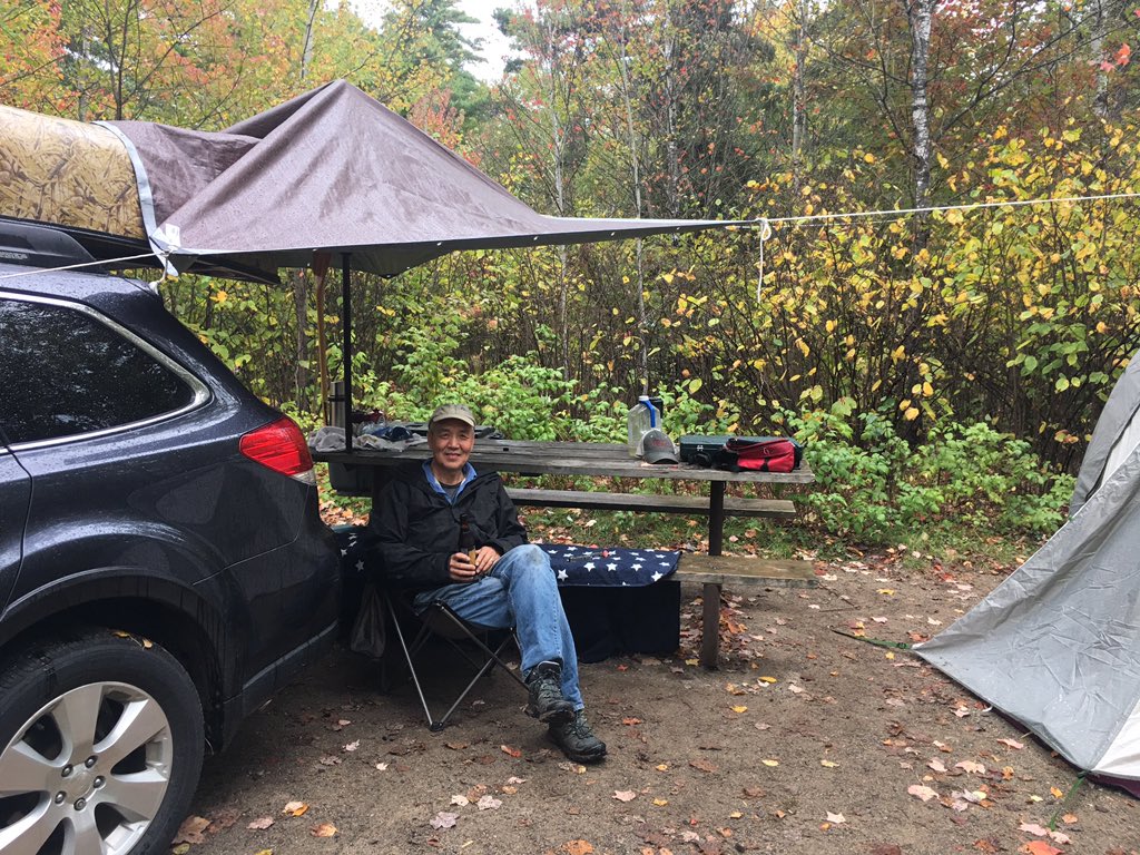 It started to rain so Yue Jin got creative. A tarp, rope, a Subaru, two trees, a canoe and two canoe paddles. Now we can cook our walleye. #wheat submit in the wilderness.