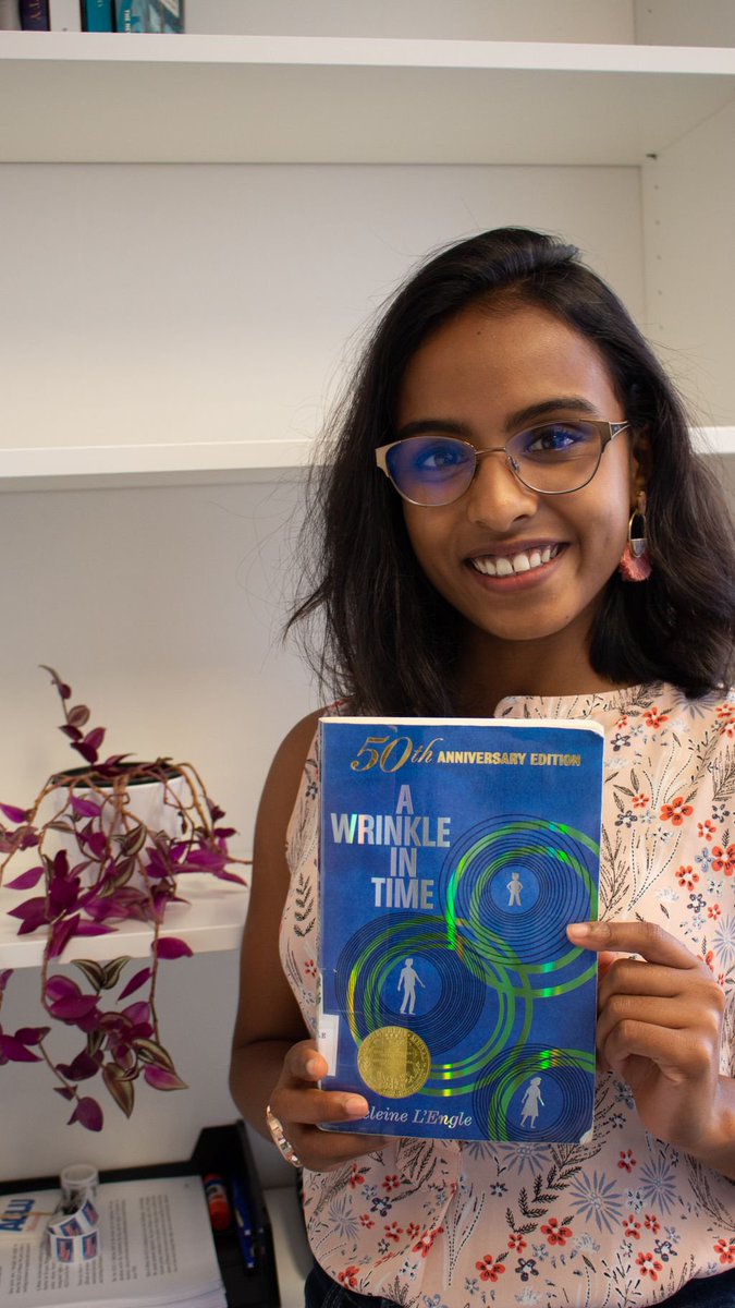 Dhivya Singaram, ACLU of Maine Engagement Coordinator/Organizer, holding a copy of A Wrinkle in Time by Madeleine L'Engle