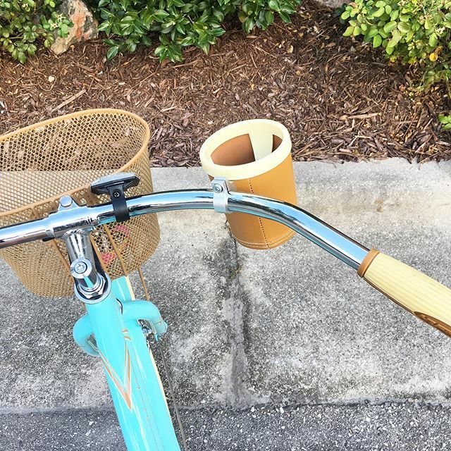 A bike with a basket and cup holder.