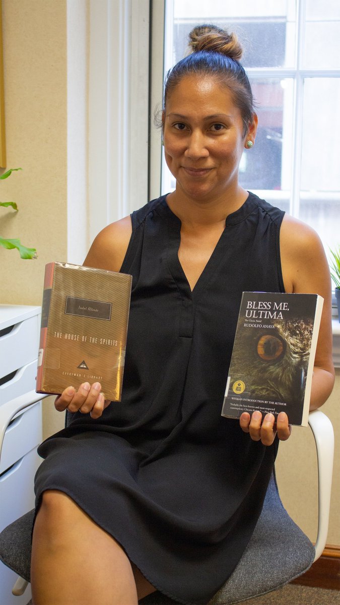 Margarita Salguero-Macklin, ACLU of Maine Office Manager, holding copies of The House of the Spirits by Isabel Allende and Bless Me, Ultima by Rudolfo Anaya