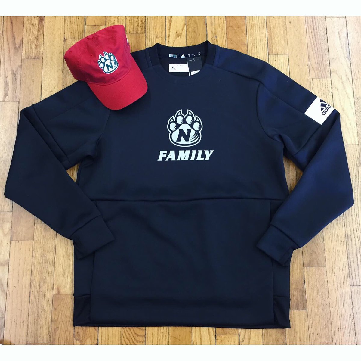 VilleJocksNitch's tweet photo. Our family tees sold out in ONE day so don’t wait to pick up this crew neck!! We also have three styles of red Adidas hats that go QUICK every single year! https://t.co/z6XugRNLqe