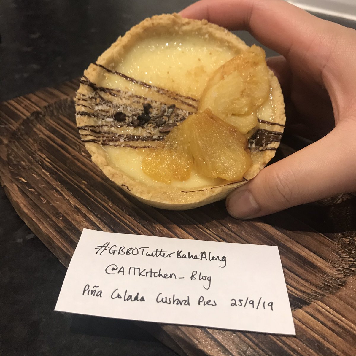 aitkitchen's tweet photo. I combined together the signature and showstopper with my Piña Colada Custard Tarts (even though I wrote pies 😂) - coconut shortcrust pastry, coconut milk and rum custard topped with toasted desiccated coconut and rum-cooked pineapple! #GBBO #1920sWeek #GBBOTwitterBakeAlong https://t.co/Vo9t4L5ngl