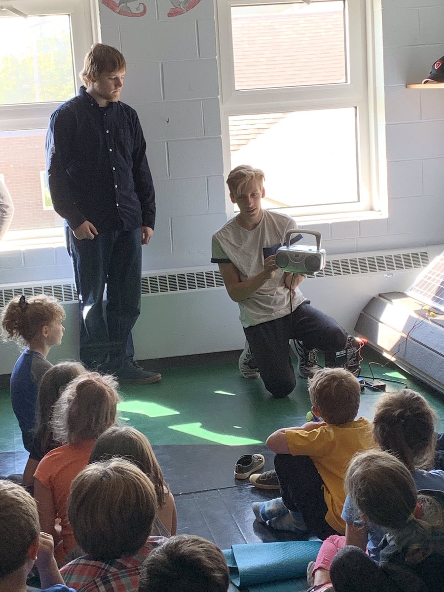 Students are captivated by Jonah explaining how a radio can work off solar power. Thanks SJDA for including VMES in your climate action plan.#sjda#climateaction. Join us tomorrow at 1:00pm in Saint Andrews as we walk for climate action.