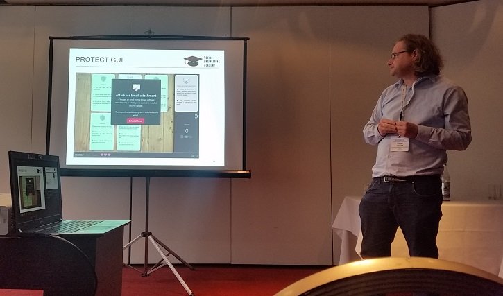 ArrestThreat's tweet photo. Ludger Goeke on "PROTECT — An Easy Configurable Serious Game to Train Employees Against Social Engineering" at #esorics2019 #MSTEC https://t.co/ZDPywHvdGv