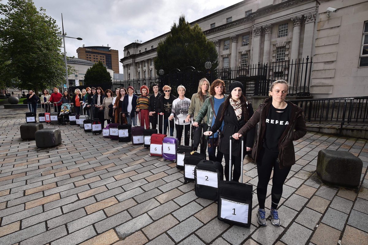 All4Choice's tweet photo. The cast of #nowforthenorth organised a perfomance art piece of 21 people with suitcases, the number who travel every week from NI to access abortion in GB. They were also pictured outside the courts because abortion is criminalised.
#healthcarenotairfare #MyAbortionMyHealth https://t.co/FgCK3mJhYL
