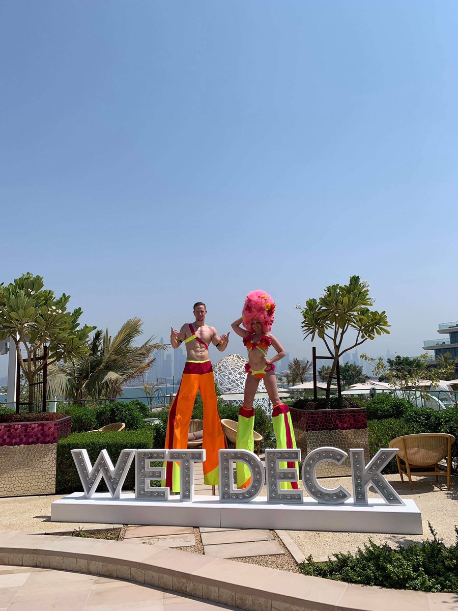 Area51crew's tweet photo. Check out these awesome shots of our duo at @wetdeckdubai 🔥☀️
We know they’re enjoying the sunshine whilst we sit in the office in the rainy UK receiving their amazing pictures 😅 
☀️❤️
#dubai #entertainment #stiltwalkers #wetdeckdubai #dubaientertainment #globalperformers https://t.co/ehsrpqN2nV