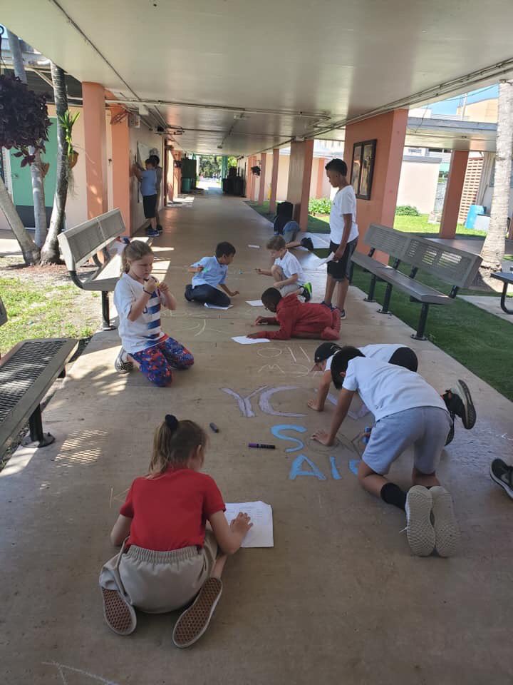 CORALREEF_PTA's tweet photo. Start with Hello Week continues! Our YCW group painted the school entrance walkway with words of “Hello” in the different languages that represent our students’ heritage. What a colorful way to start our day! #startwithhello #valuesmattermiami #CRECares #SandyHookPromise https://t.co/NIucrq2LOO