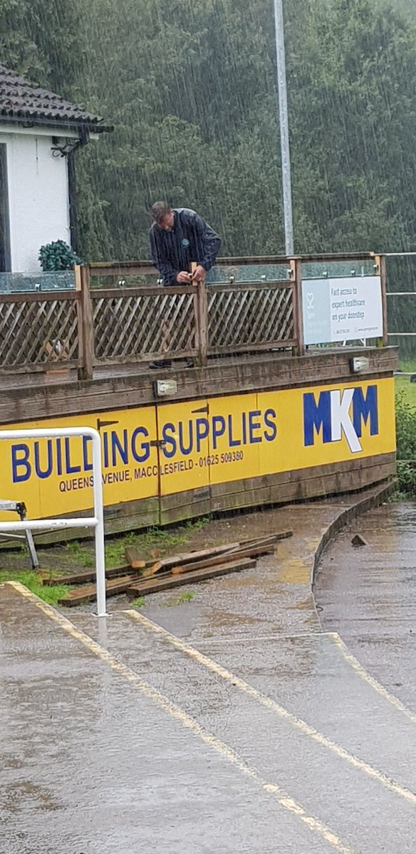 Keith Davies working hard fitting glass panels to clubhouse decking, thanks to sponsors @PremierEstates_