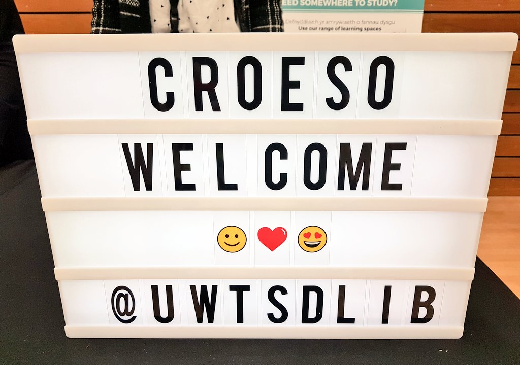 StudyUWTSD's tweet photo. Bottles, books &amp; beyond. . .  Second year @fineartswansea student Phoebe Taylor &amp; lovely @UWTSDLib staff enjoy a chat at the #Swansea Welcome Fair at the LC2. Explore what the library service has to offer @uwtsd. https://t.co/FYVXACAyDR