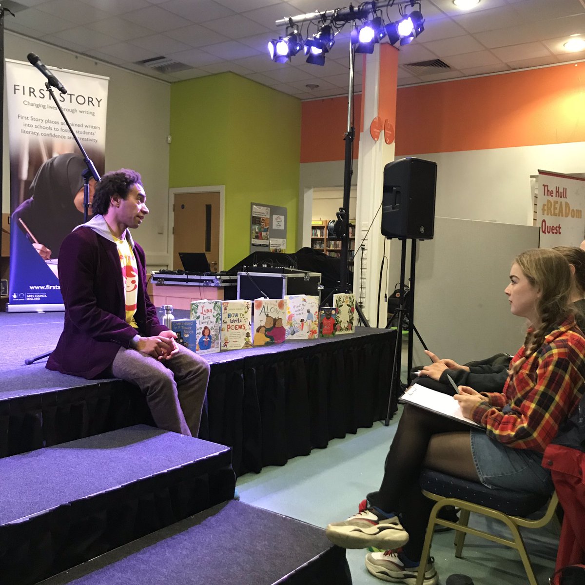 FirstStory's tweet photo. The wonderful @Poetryjoe leading a workshop for our First Story students and members of the public in #Hull. Goes to show what a unifying activity creative writing is: people of all ages reading their fresh-out-the-pen poetry to one another. 📝✍🏼 #bbccontainsstronglanguage https://t.co/uJ714O2noe