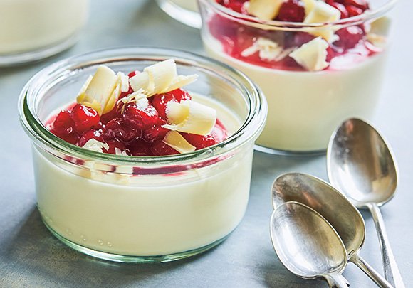 This smooth and creamy panna cotta is topped with cranberries and white chocolate shavings. bit.ly/2nfElsX