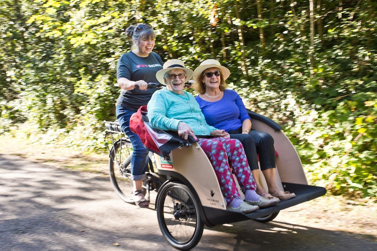 LisaLambon's tweet photo. Fresh air and friendship... 
How fab is this new partnership between care home charity @LilianFaithfull and #Cheltenham company @cellosignal who bought a 'trishaw’ so employees can take residents #cycling in their breaks? https://t.co/14UM8cLuZu @CycleWithoutAge https://t.co/fh5fE0kiPg